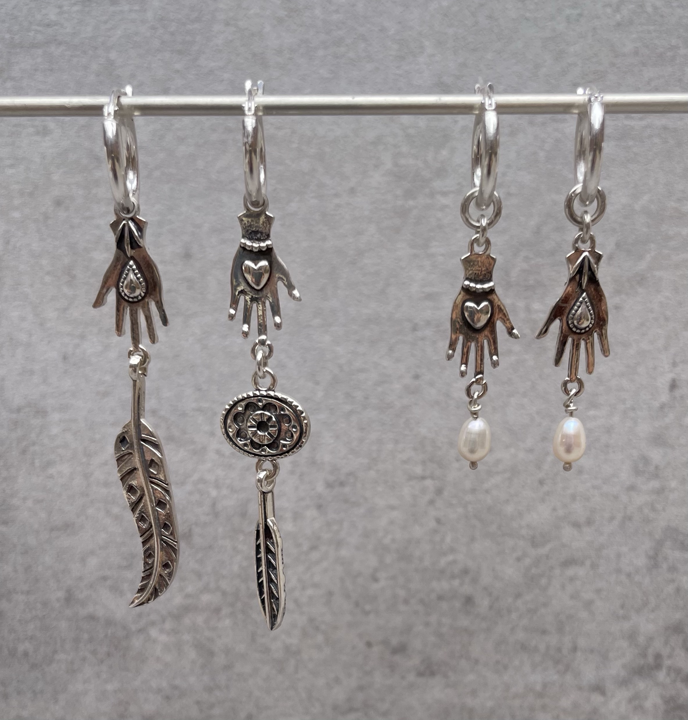 Hand drop earrings on bar